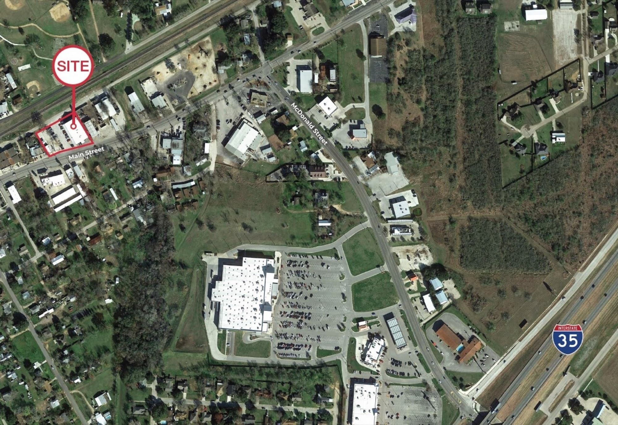 Aerial site map of 15033 Main St in Lytle, TX, with the I-35 corridor visible and surrounding retail context